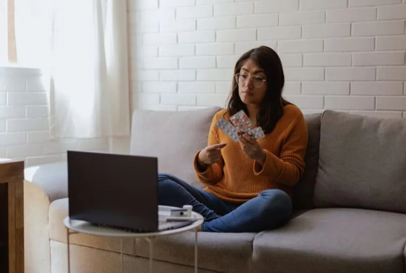 Woman using a laptop for a telehealth appointment with her physician
