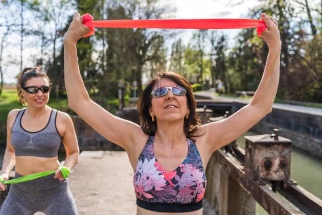 Women doing resistance training to provide essential mechanical loading. This signals to your skeleton that its density is still required. It actively counteracts the "astronaut effect."