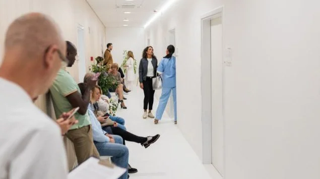 A photo of a packed hospital waiting room