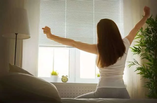Photo of a woman waking up to spring for the article Spring into Wellness plan