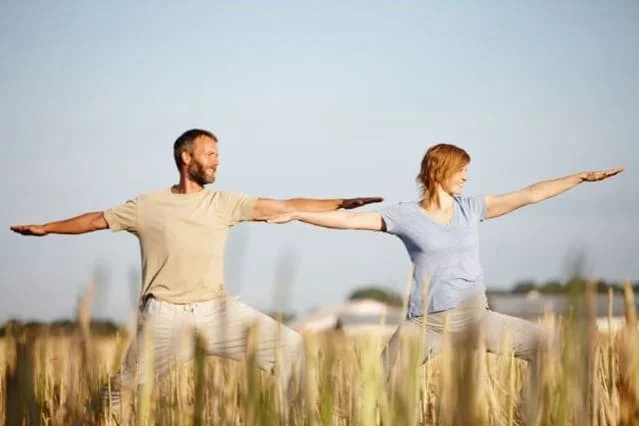 Photo of a couple exercising outdoors for the article Spring into Wellness plan