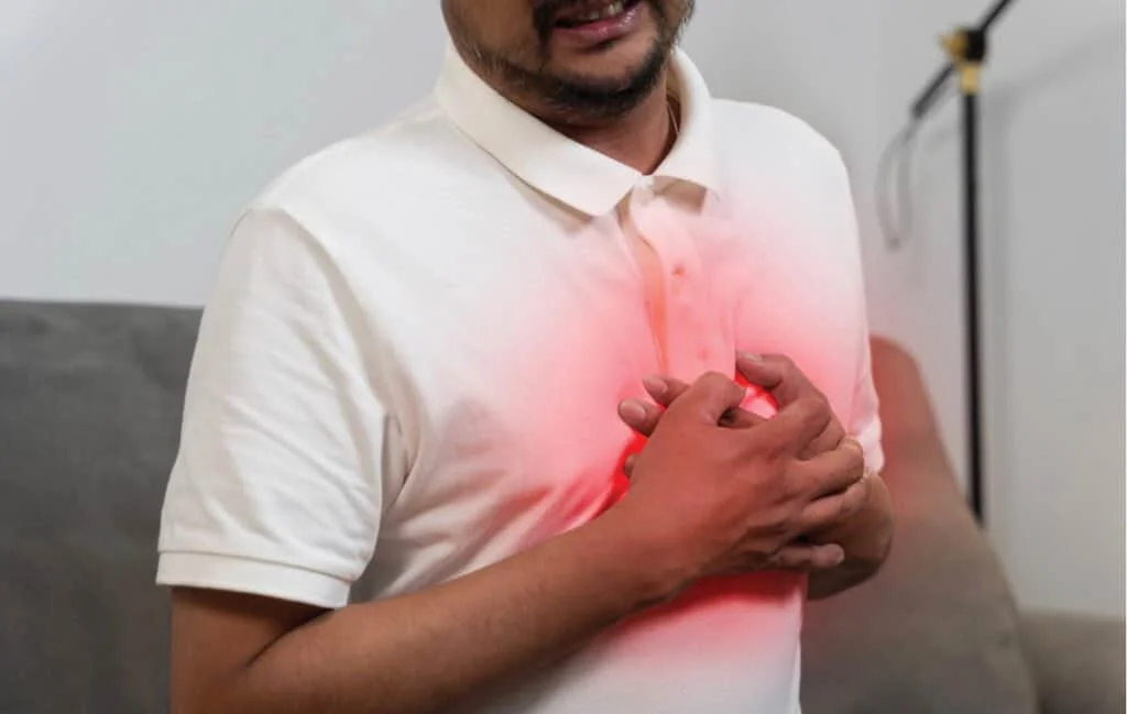 Middle-aged man suffering from heart attack for the blog post The 6 Silent Killers Men Ignore (And the Simple Habits That Add Years to Your Life)