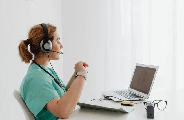 A healthcare provider doing telehealth via a laptop