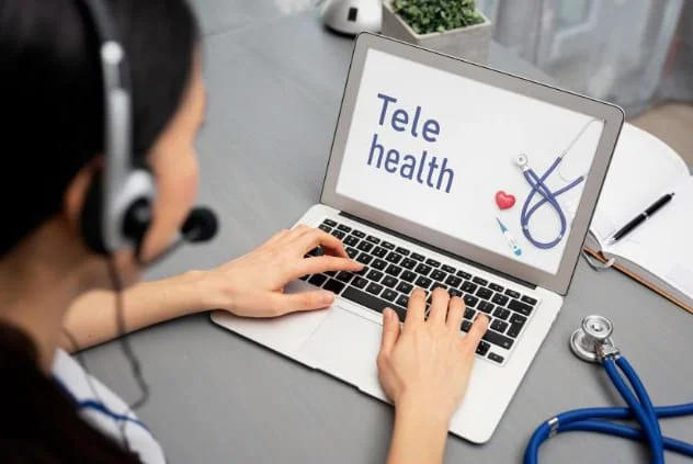 Photo of a healthcare provider doing a telehealth consult on her laptop