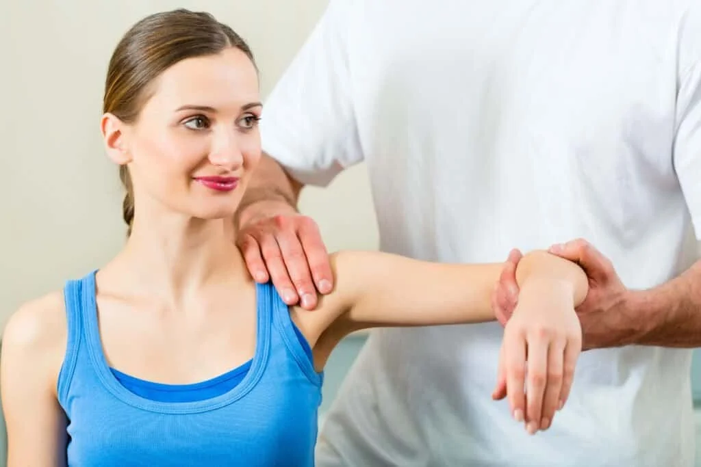 Woman getting examined by a physical therapist