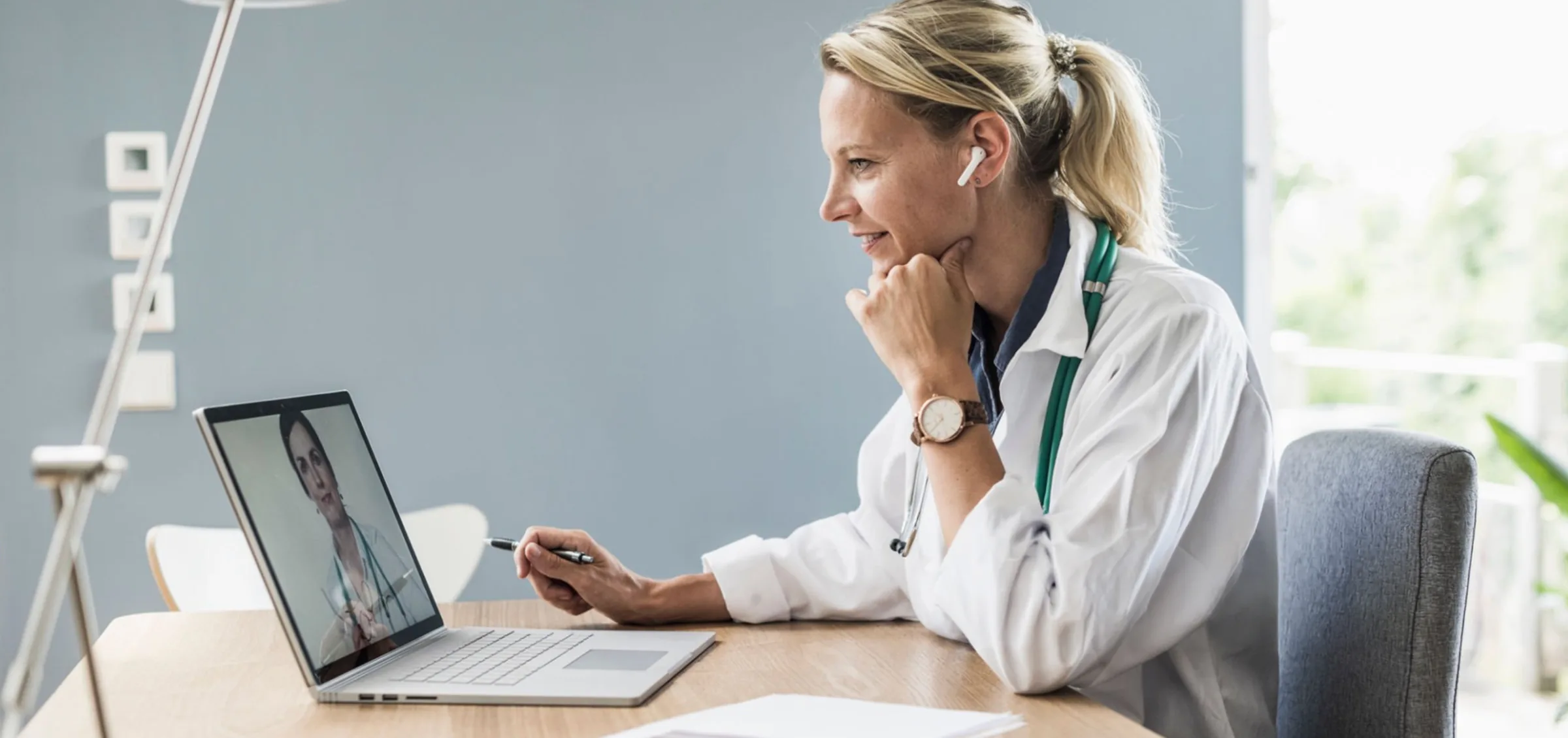Clinician discussing telehealth consulting during a video call