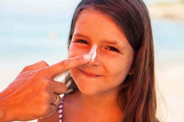 Photo-of-child-applying-sun-screen-for-the-telehealth-blog-summer-safety-tips