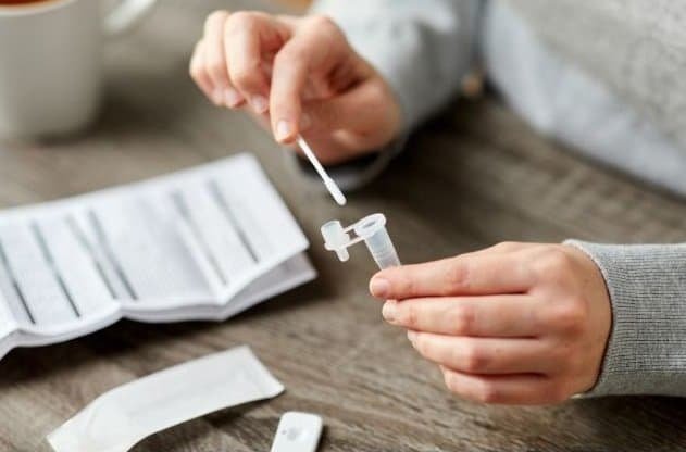 Woman Making Self Testing Coronavirus Test at Home