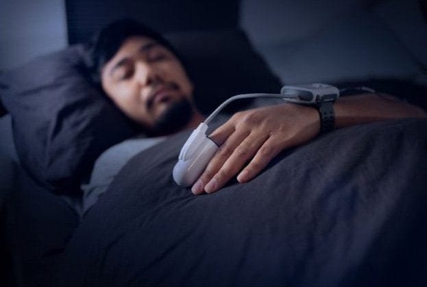 Man Wearing a Pulse Oximeter - At Home Sleep Study Test for Sleep Apnea