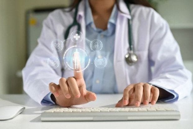A futuristic image of telehealth where a healthcare provider uses a touch screen with no visible form