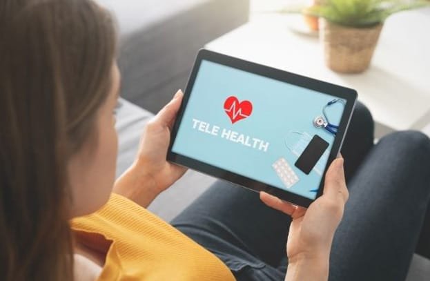 Woman using telehealth on her tablet