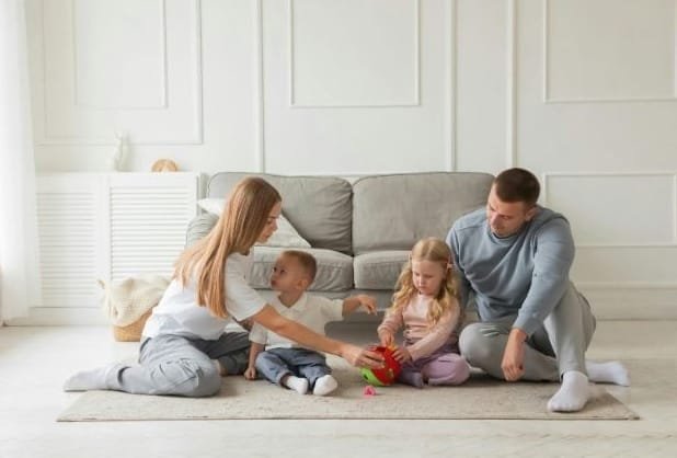 Happy and healthy family playing together in living room