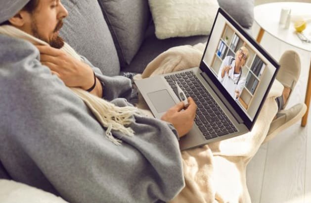 Photo of person sick with the flu doing a telehealth consultation