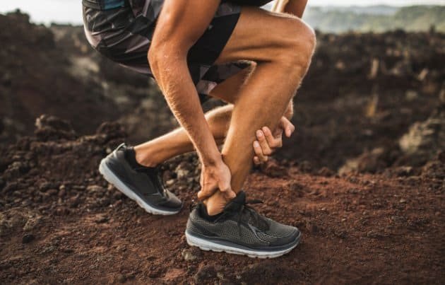 Person with a sharp ache in his achilles tendon for the blog post on peptides for joint pain in athletes
