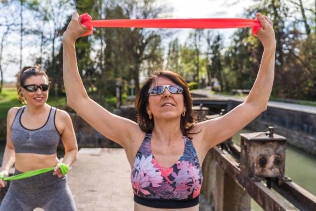 Women doing resistance training to provide essential mechanical loading. This signals to your skeleton that its density is still required. It actively counteracts the "astronaut effect."