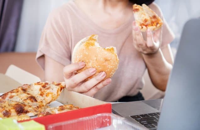 woman binge eating for the blog post on managing disordered eating patterns during the menopause transition